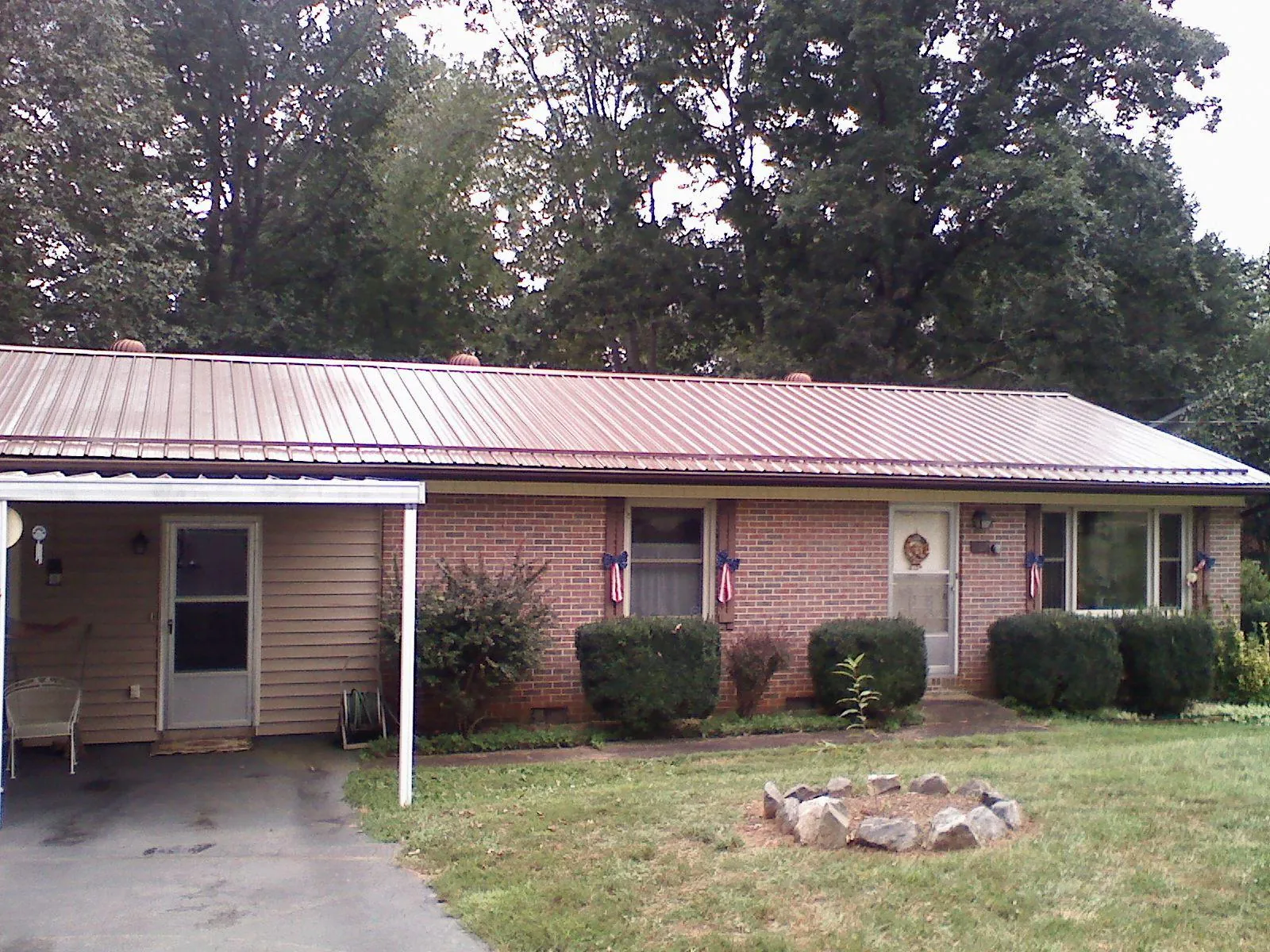 Bronze metal roof and carport on a brick ranch home — Roof Repair work by our crew in Rockaway