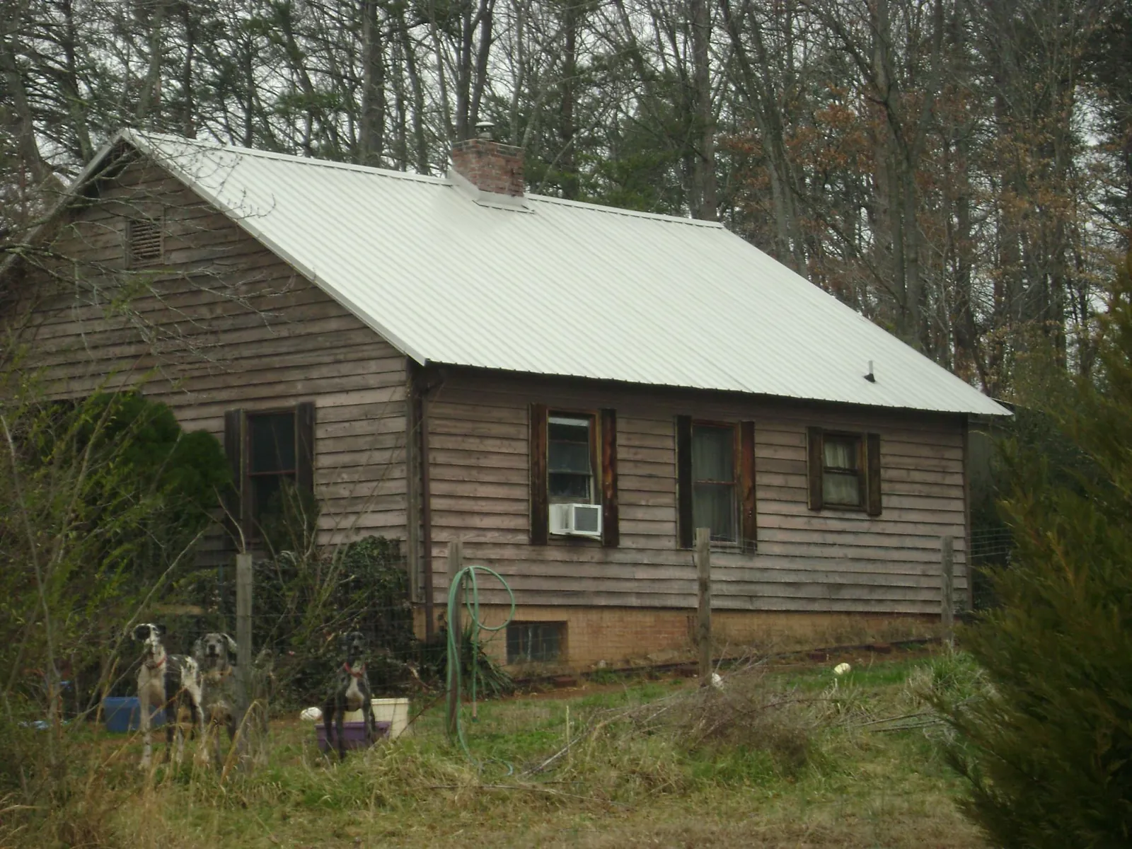 White metal roof on an old wood sided farmhouse, from a Metal Roof Installation job in Rockaway